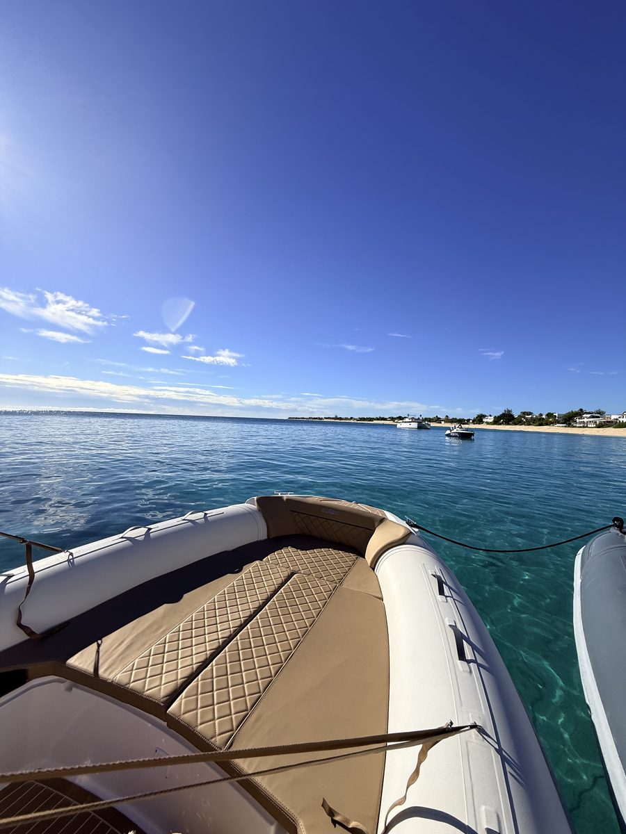 At anchor off La Samanna, the boat's bow and Baie Longue beach in the distance