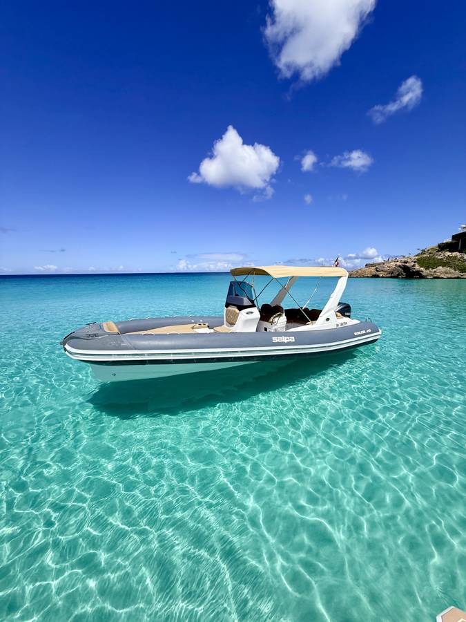 The RIB Paloma at anchor over a sandy bottom in turquoise water, Saint-Martin